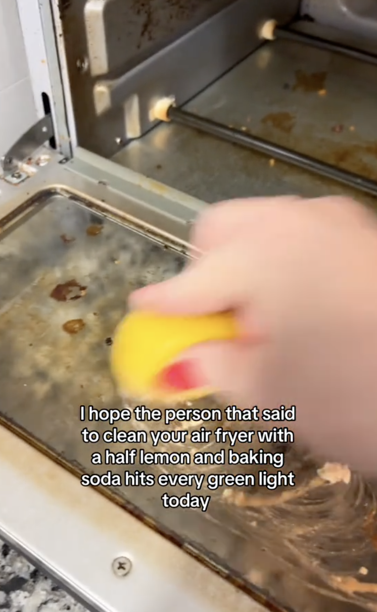 an air fryer being cleaned